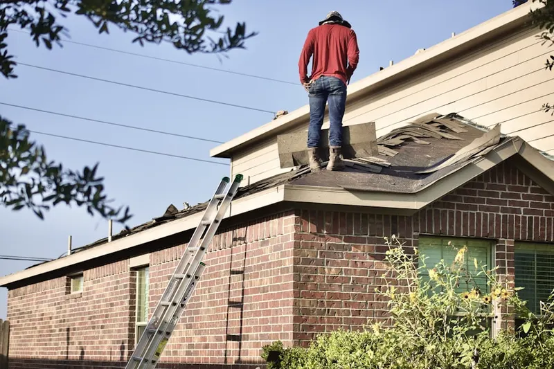 Professional roofer working on a residential roof in Denver